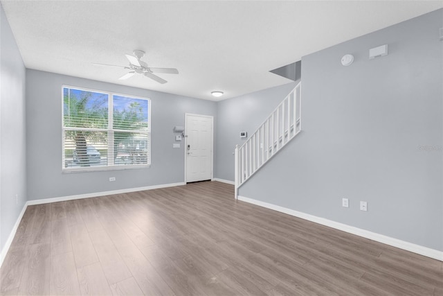 foyer with ceiling fan, wood-type flooring, and a textured ceiling