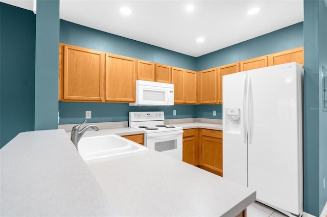 kitchen with white appliances, sink, and light tile patterned floors