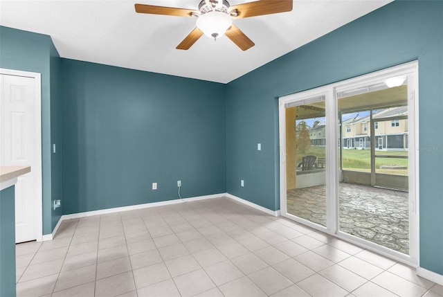 empty room featuring ceiling fan and light tile patterned floors