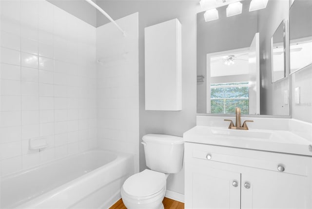 full bathroom featuring vanity, hardwood / wood-style flooring, toilet, and tiled shower / bath