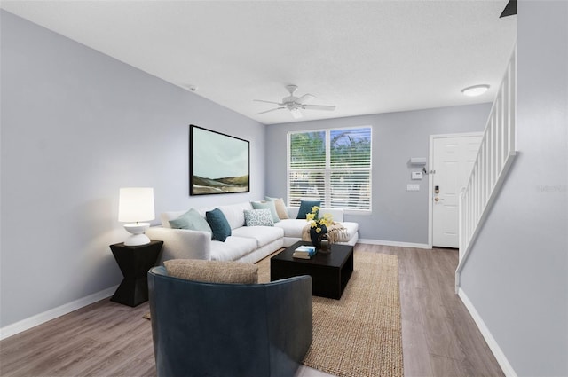 living room with ceiling fan and wood-type flooring