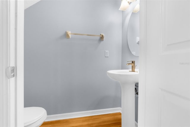 bathroom featuring toilet and hardwood / wood-style flooring