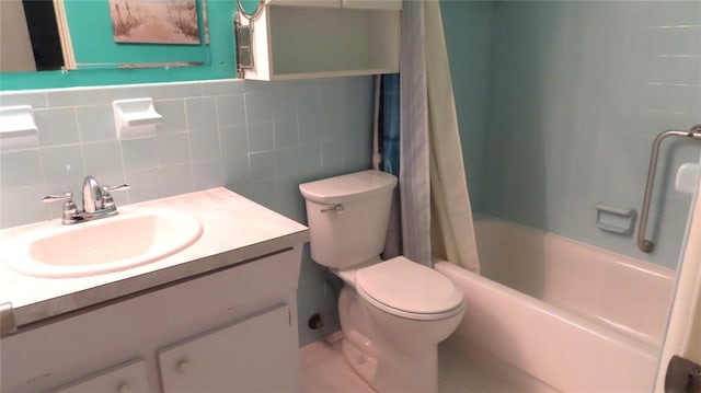 full bathroom with tile walls, toilet, vanity, and shower / bathtub combination with curtain