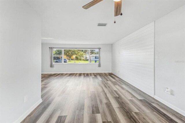 empty room with hardwood / wood-style flooring and ceiling fan