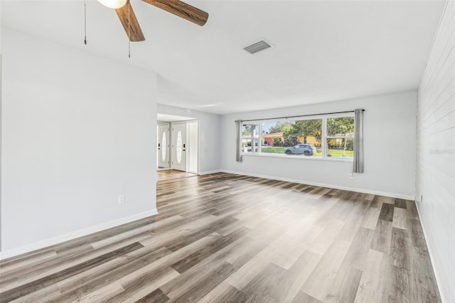 unfurnished room with ceiling fan and light wood-type flooring