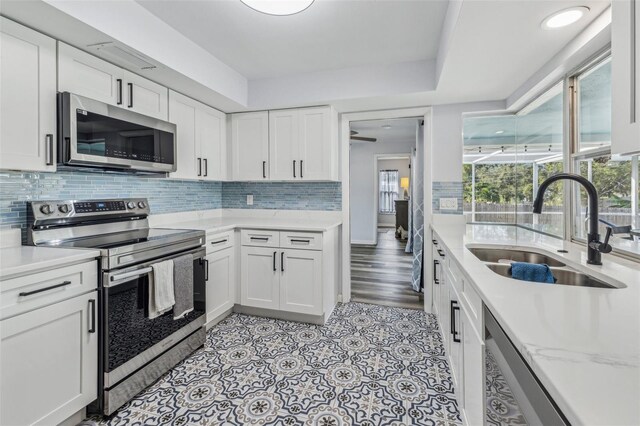 kitchen featuring white cabinets, sink, and stainless steel appliances