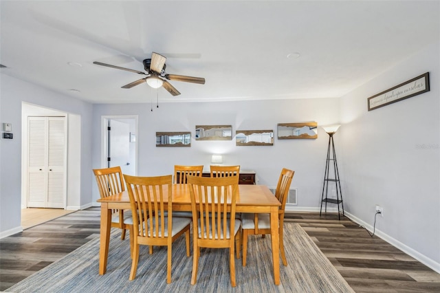 dining area featuring dark hardwood / wood-style floors and ceiling fan