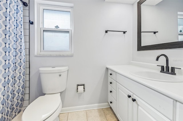 bathroom featuring tile patterned flooring, vanity, toilet, and curtained shower