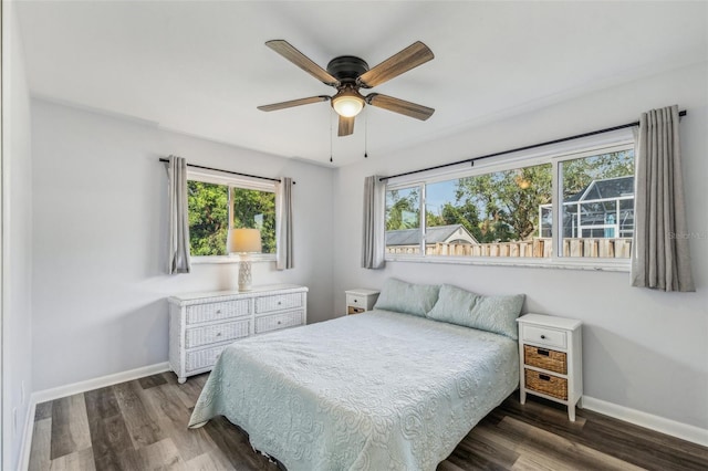 bedroom with ceiling fan and dark wood-type flooring