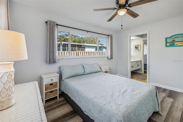 bedroom featuring ensuite bath, ceiling fan, and dark wood-type flooring