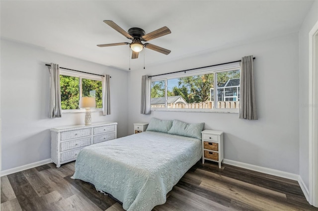 bedroom with dark hardwood / wood-style floors and ceiling fan