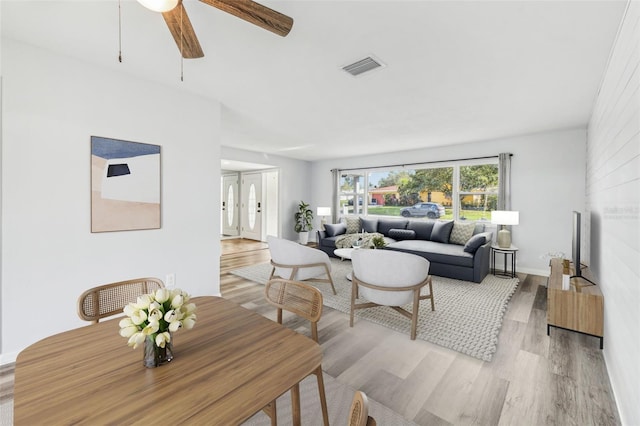 living room featuring light hardwood / wood-style flooring and ceiling fan