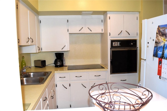 kitchen with white cabinetry, sink, and black appliances