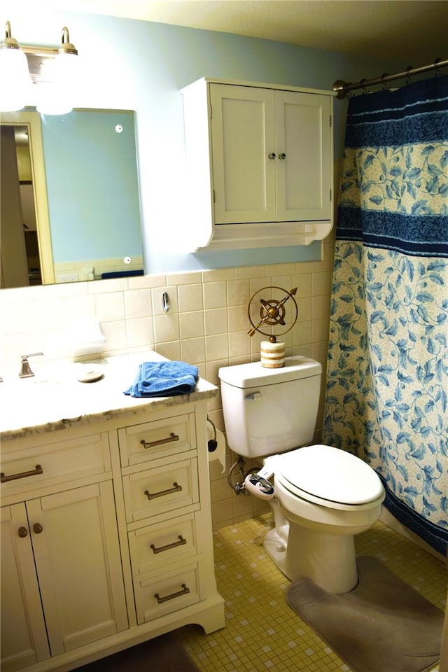 bathroom featuring curtained shower, tile walls, and toilet