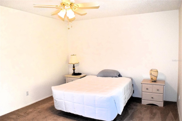 carpeted bedroom with a textured ceiling and ceiling fan