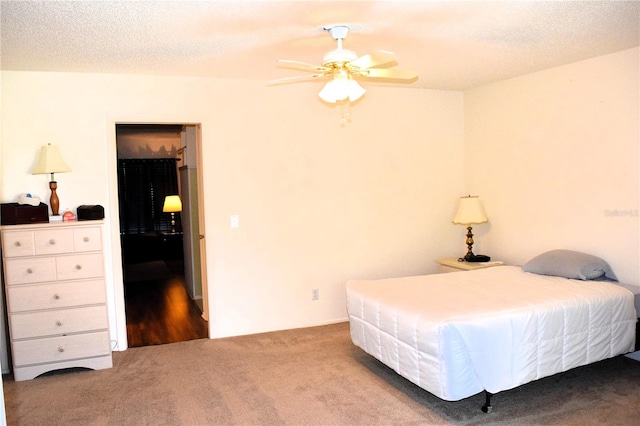 bedroom with carpet, ceiling fan, and a textured ceiling