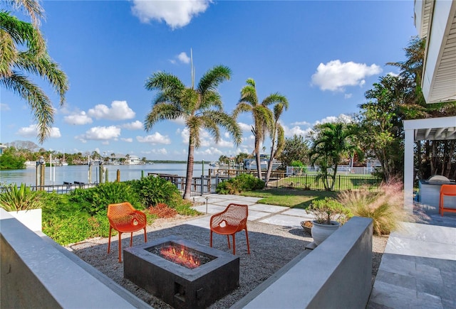 view of patio / terrace with a dock, a water view, and a fire pit