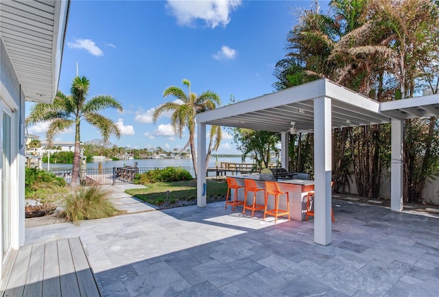 view of patio with a bar and a water view