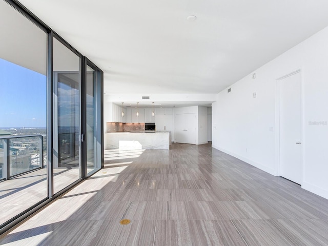 unfurnished living room with a wall of windows