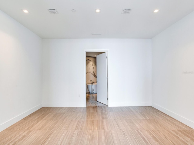 spare room featuring light hardwood / wood-style flooring