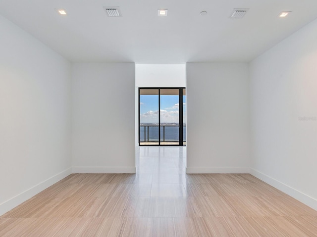 unfurnished room with light wood-type flooring