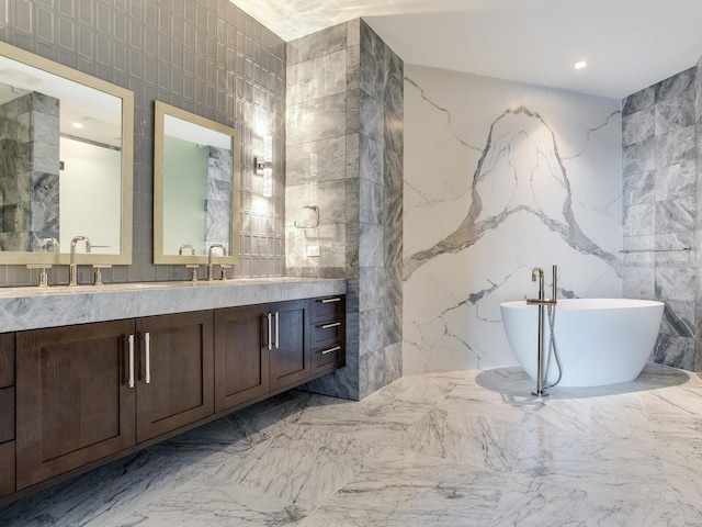 bathroom featuring vanity, tile walls, and a bathing tub