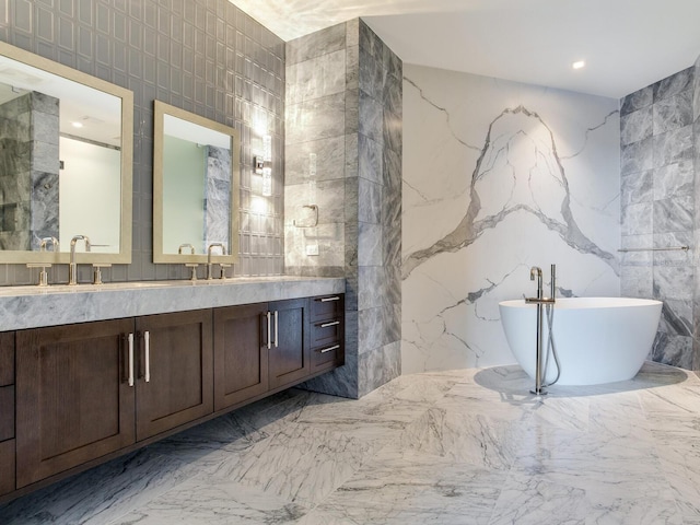 2912 W Santiago St Unit 2204, Tampa, FL 33629 - full bath featuring double vanity, a freestanding tub, tile walls, and marble tiled floors