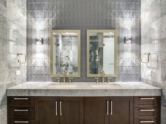 bathroom featuring vanity and tile walls