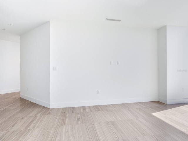 unfurnished room with light wood-type flooring