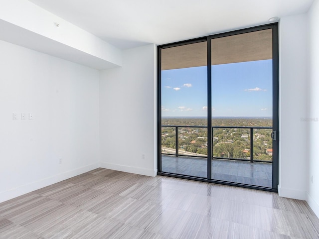 unfurnished room with expansive windows