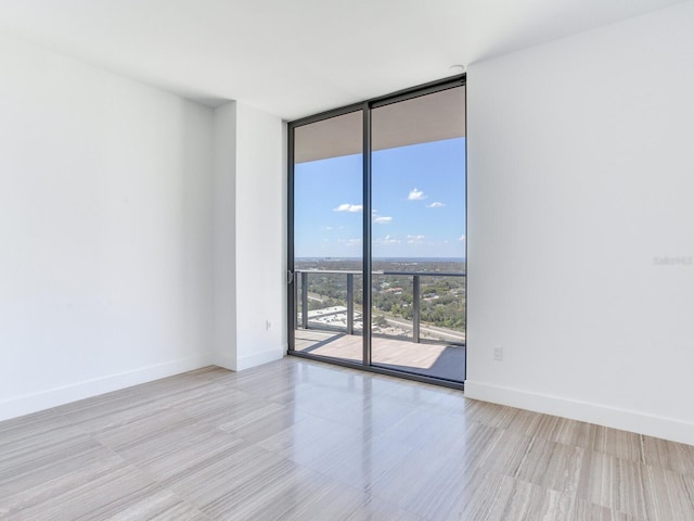 unfurnished room featuring expansive windows