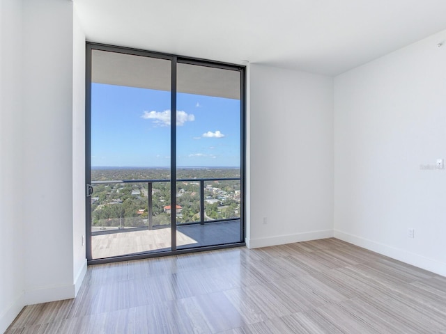 unfurnished room featuring expansive windows