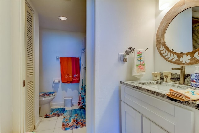 bathroom featuring tile patterned flooring, vanity, and toilet