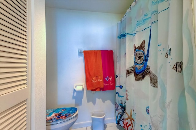 bathroom with tile patterned flooring and toilet