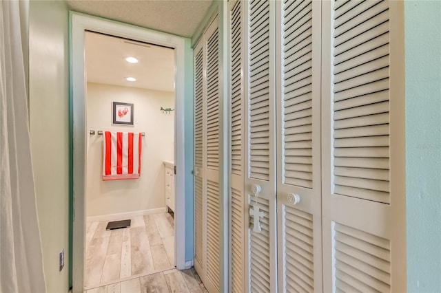 hallway with light hardwood / wood-style flooring