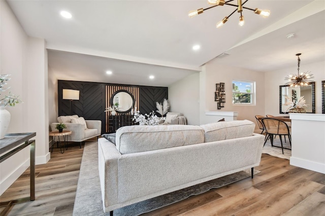 living room with hardwood / wood-style flooring and a notable chandelier