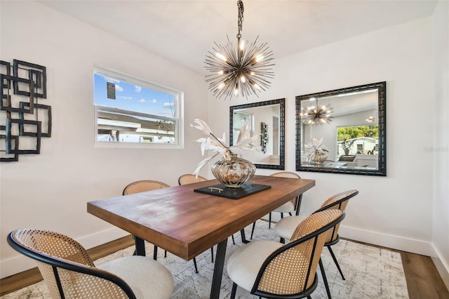 dining room with a notable chandelier and light hardwood / wood-style flooring