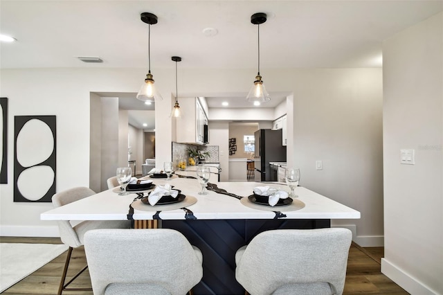 dining space with dark hardwood / wood-style flooring