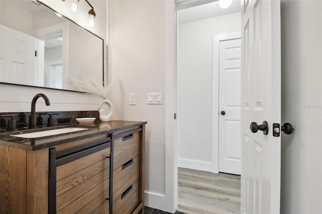 bathroom featuring hardwood / wood-style flooring and vanity