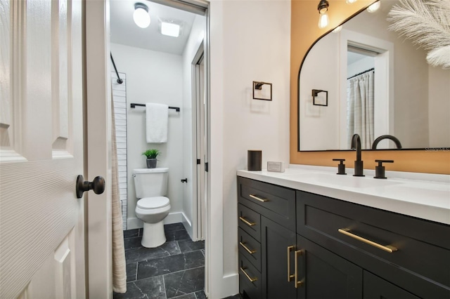 bathroom featuring toilet and vanity