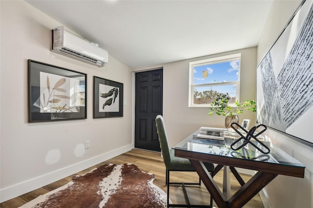 home office featuring a wall mounted AC and hardwood / wood-style floors