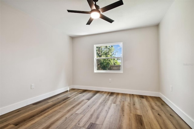 spare room with light hardwood / wood-style flooring and ceiling fan