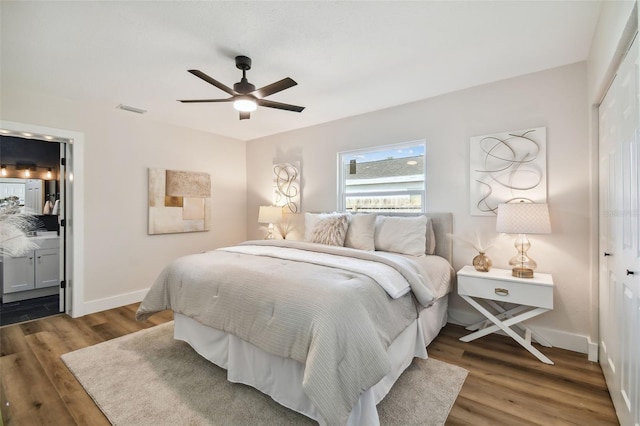 bedroom with ceiling fan, a closet, ensuite bathroom, and dark hardwood / wood-style flooring