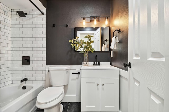 full bathroom featuring vanity, tiled shower / bath, and toilet