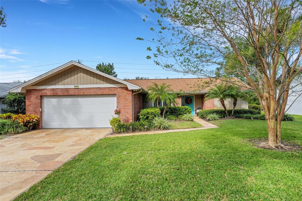 ranch-style home featuring a front lawn and a garage