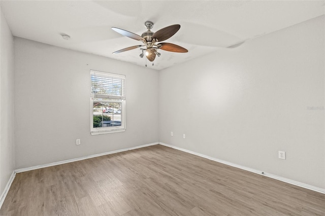 empty room with ceiling fan and hardwood / wood-style floors