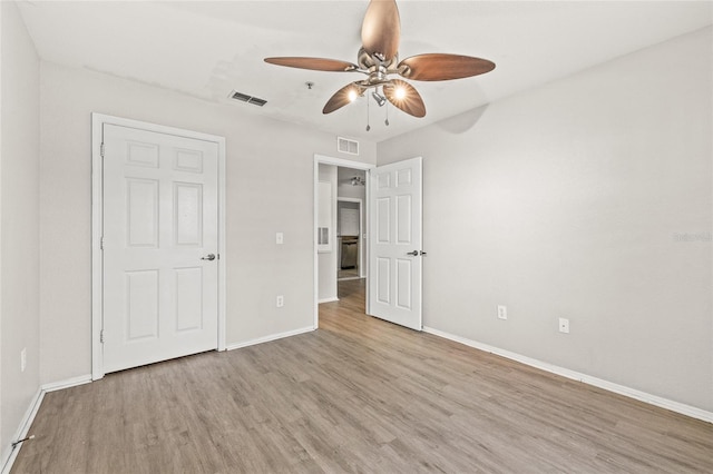 unfurnished bedroom with ceiling fan and light wood-type flooring