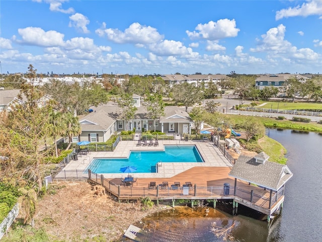 view of pool with a water view and a patio