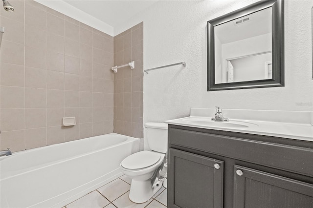 full bathroom with toilet, tile patterned flooring, vanity, and tiled shower / bath