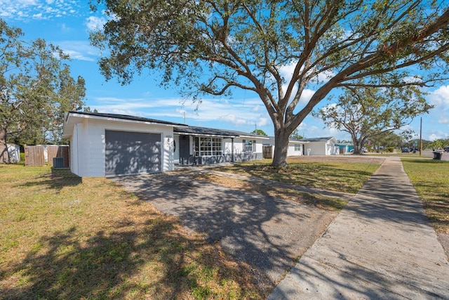 ranch-style house with a front yard and a garage